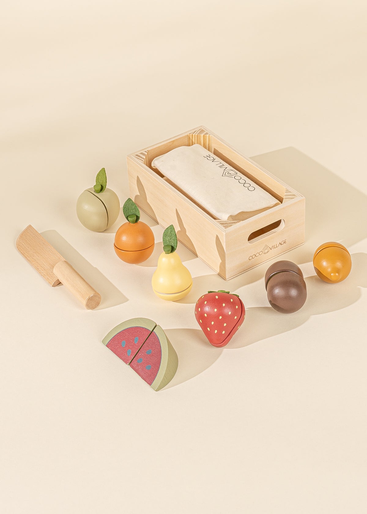 Set of wooden fruit toys with a box on a beige background