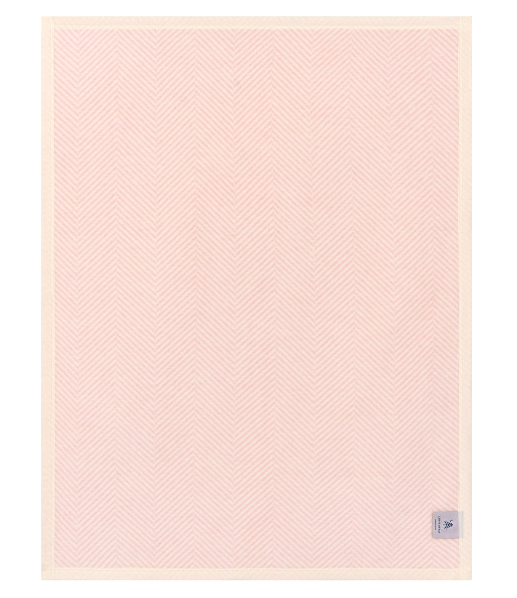 Pink textured blanket with a small logo on a white background