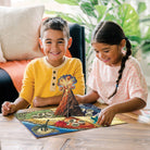 Two children playing with a science kit on a table.