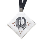 White pouch with a black and white illustration of a face with a beard and mustache, surrounded by small red symbols, on a white background.