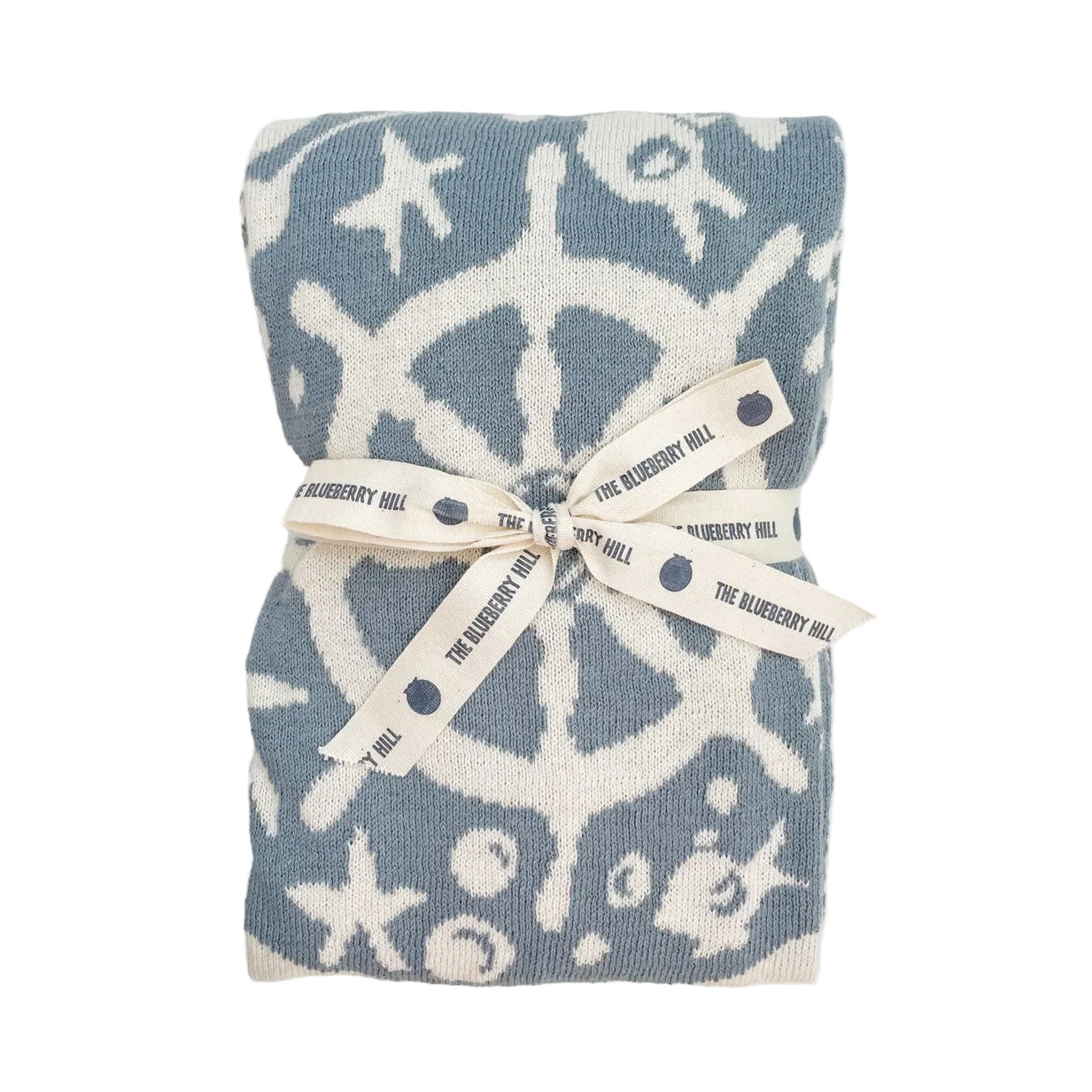Folded blanket with starfish pattern and 'The Blueberry Hill' label on a white background