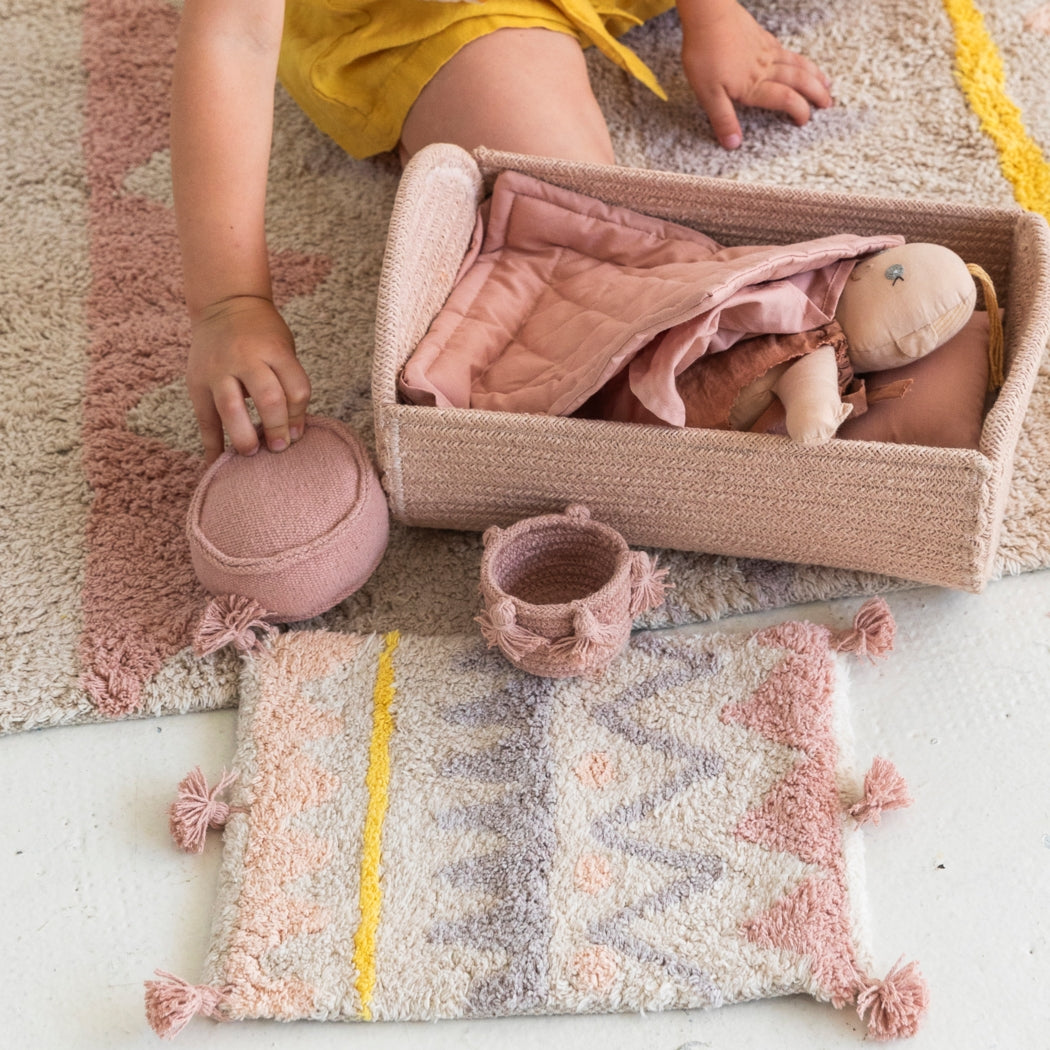 Child playing with toys on a textured rug