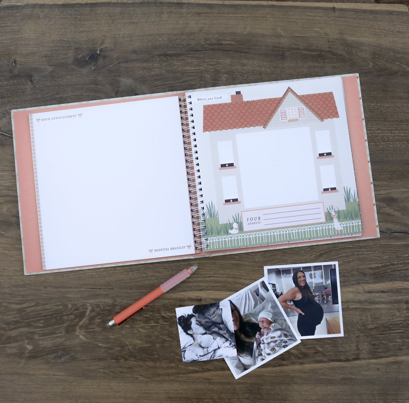 Open notebook with house illustration, pen, and photos on a wooden surface