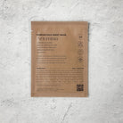 Korean face sheet mask packaging with text and a QR code on a textured white background