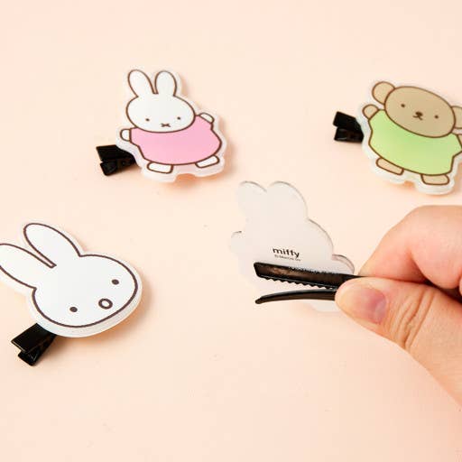 Cartoon character hair clips on a beige background