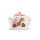 Decorative teapot with floral and leaf designs on a white background