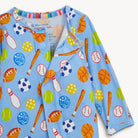 Children's outfit with sports-themed pattern on a light blue background