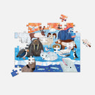 In-progress Mudpuppy Arctic Above & Below 100 Piece Double-Sided Puzzle showing an illustrated arctic scene with animals like a walrus, puffin, seal, and arctic fox.