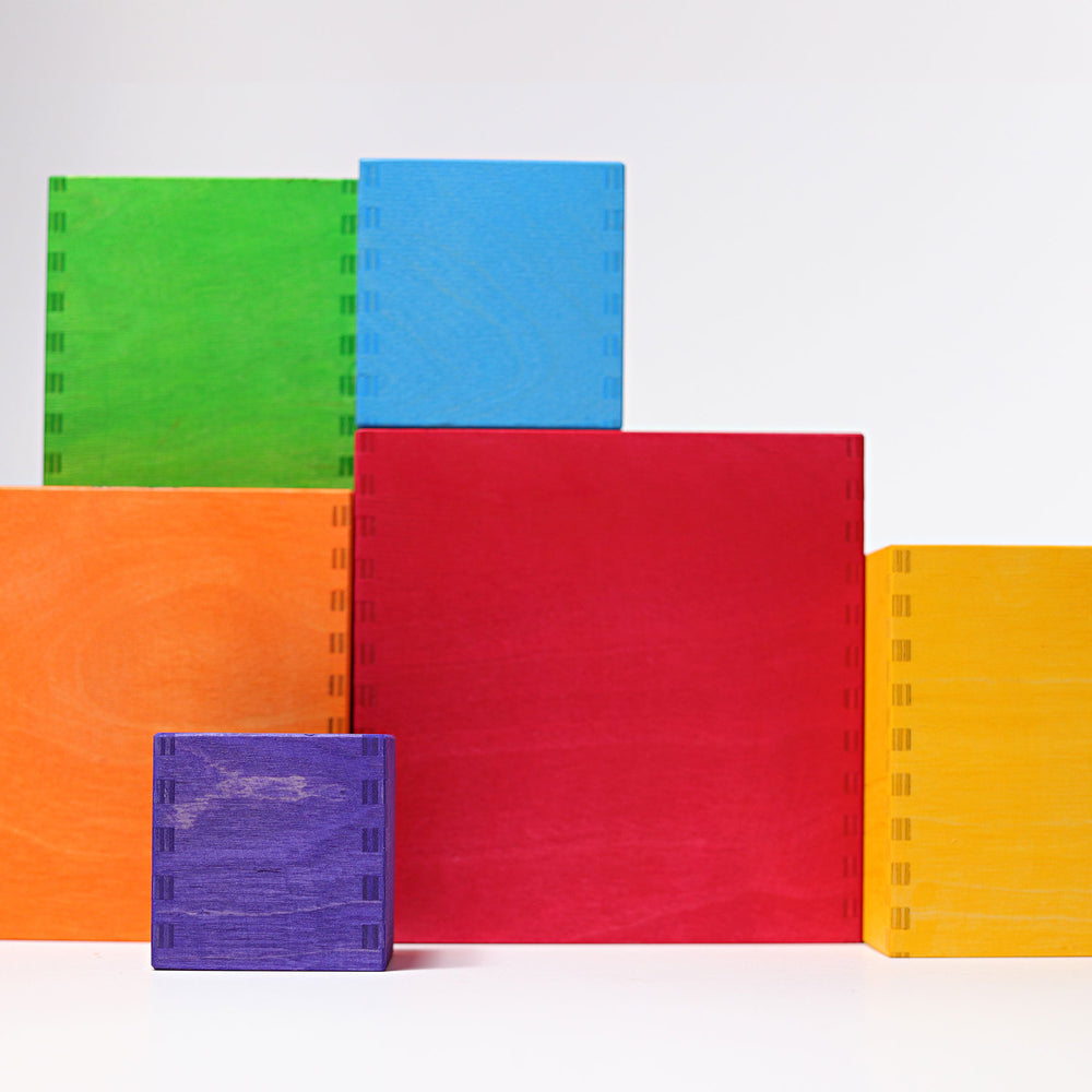 Set of colorful notebooks in green, blue, red, orange, and purple on a white background