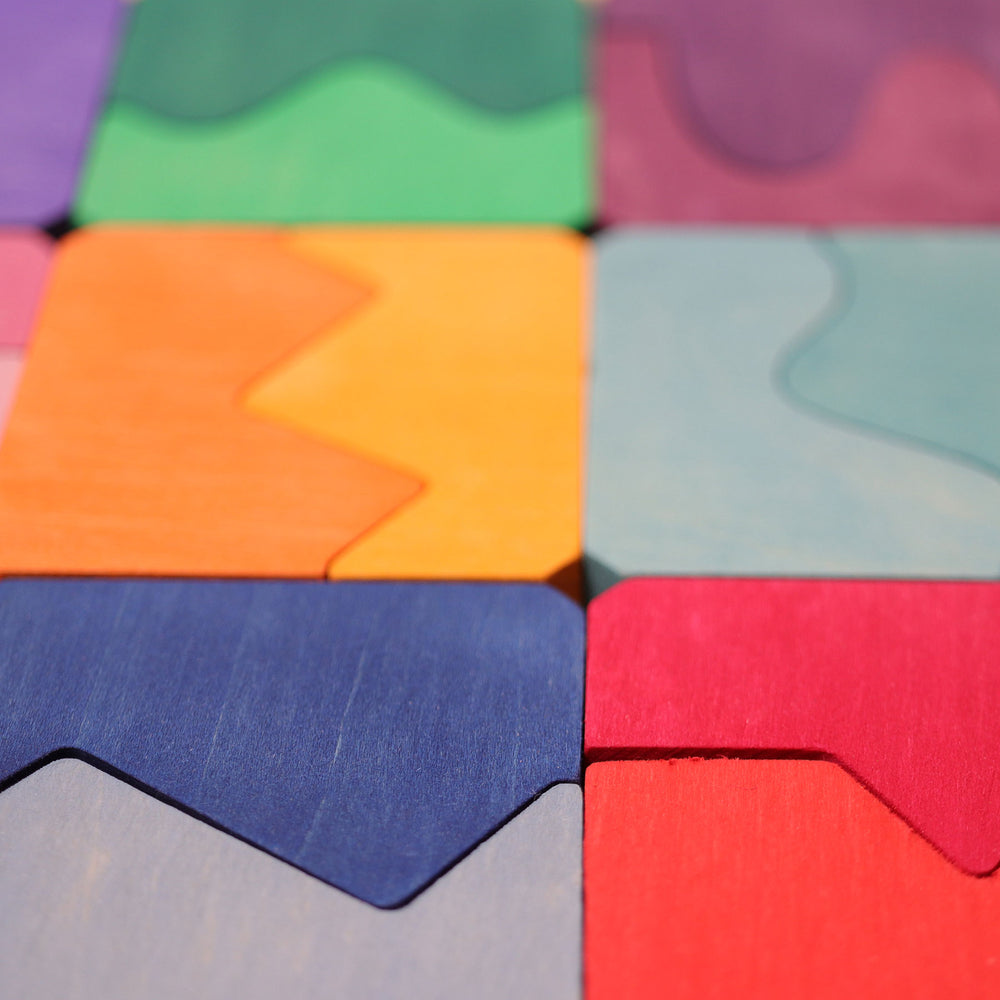 Colorful wooden puzzle pieces arranged in a pattern