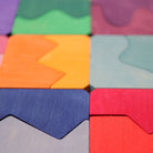 Colorful wooden puzzle pieces arranged in a pattern