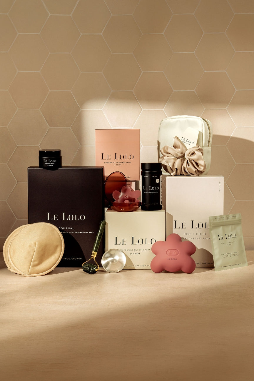 Collection of Le Lolo products on a beige surface with a geometric patterned wall in the background.