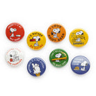 Set of colorful buttons with Snoopy illustrations and humorous text on a white background