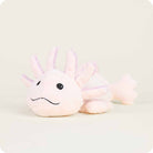 A side-angle view of the Pink Axolotl by Warmies plush toy resting on a neutral surface, showcasing its soft light pink body, embroidered smiling face, and fluffy external gills.
