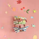 Set of colorful hairbands on a pink background with decorative elements