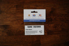 Saint Tattoos packaging on a wooden surface
