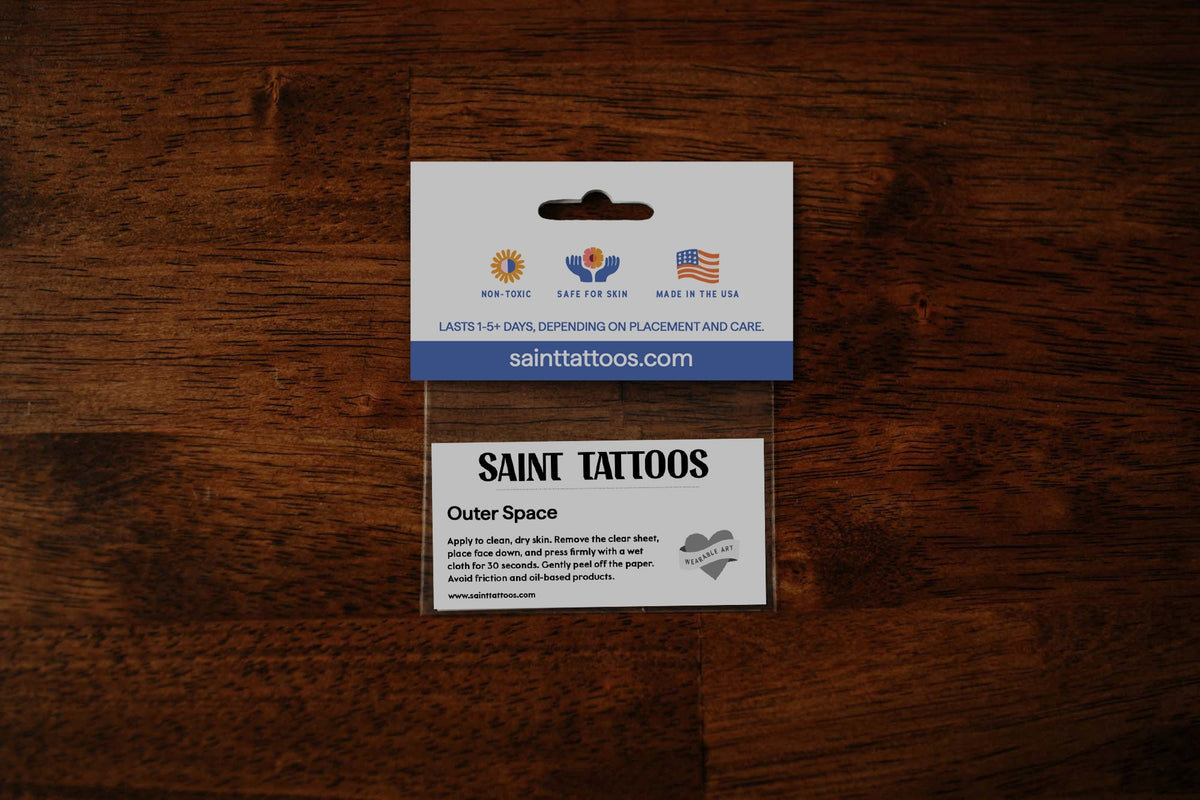 Saint Tattoos packaging on a wooden surface