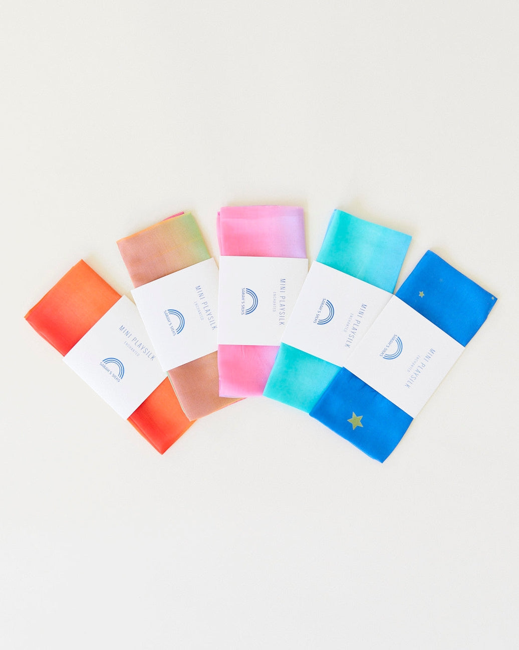Set of colorful soap bars with packaging on a light background