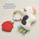 Plush sheep toy with pacifier clip on a light background