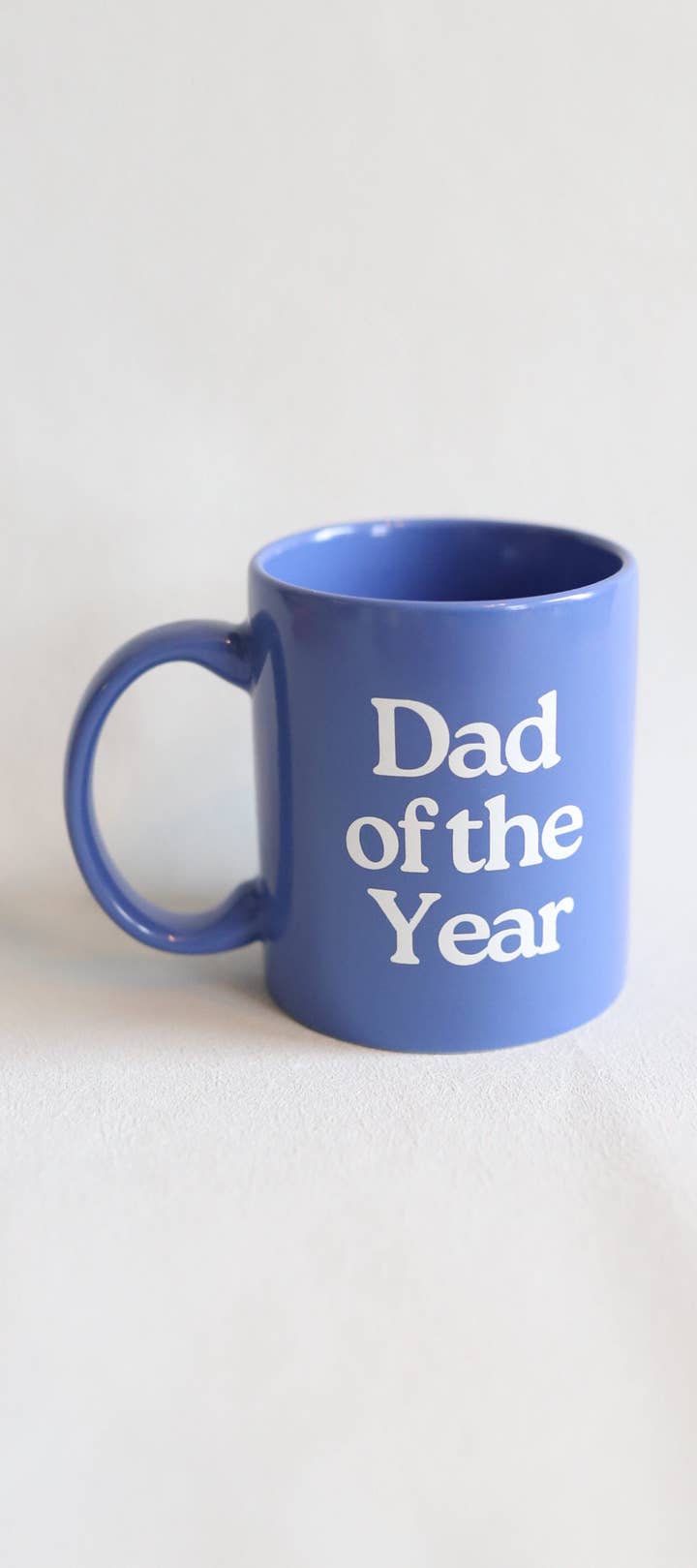Blue mug with 'Dad of the Year' text on a white background