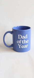 Blue mug with 'Dad of the Year' text on a white background
