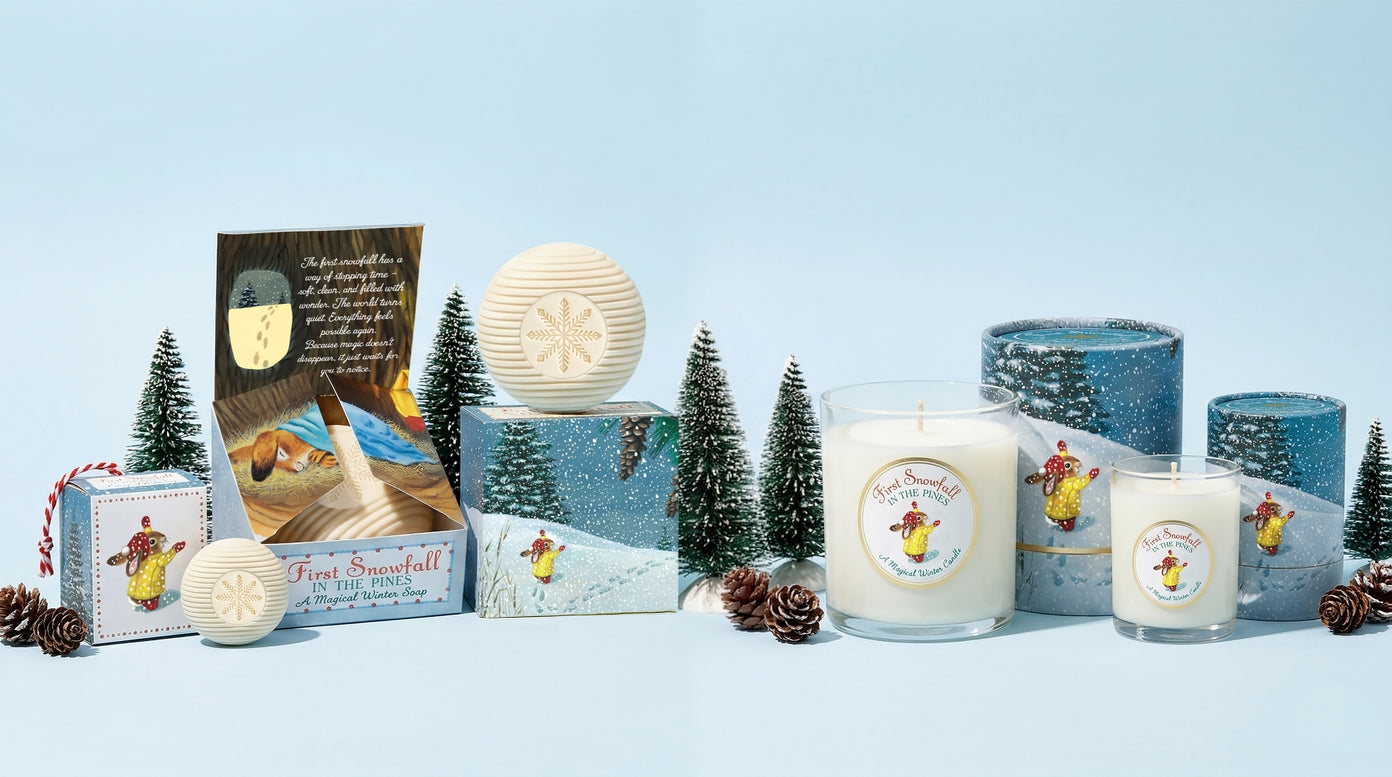 Collection of candles and packaging on a light blue background with decorative trees.