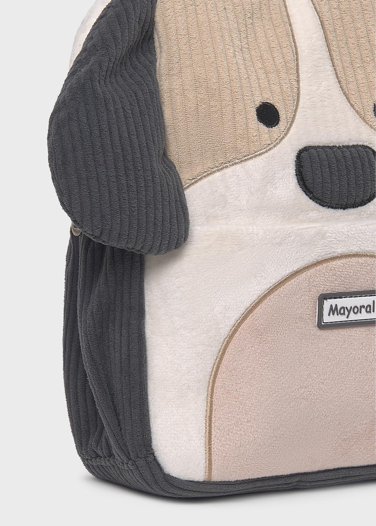 Dog-shaped backpack with a visible brand label on a light gray background