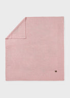 Pink textured blanket on a light gray background