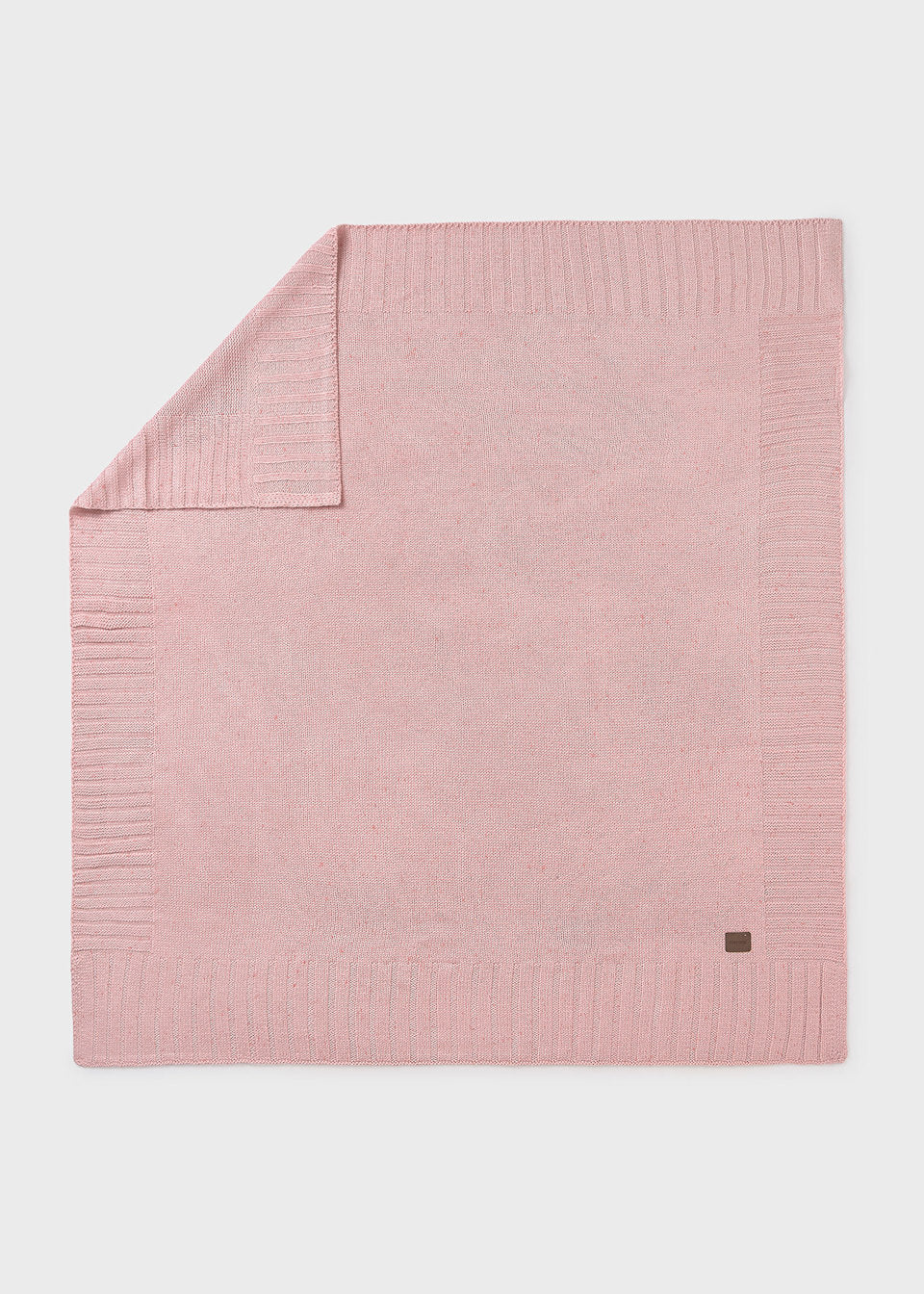 Pink textured blanket on a light gray background