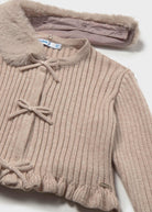 Beige ribbed sweater with bow details on a white background