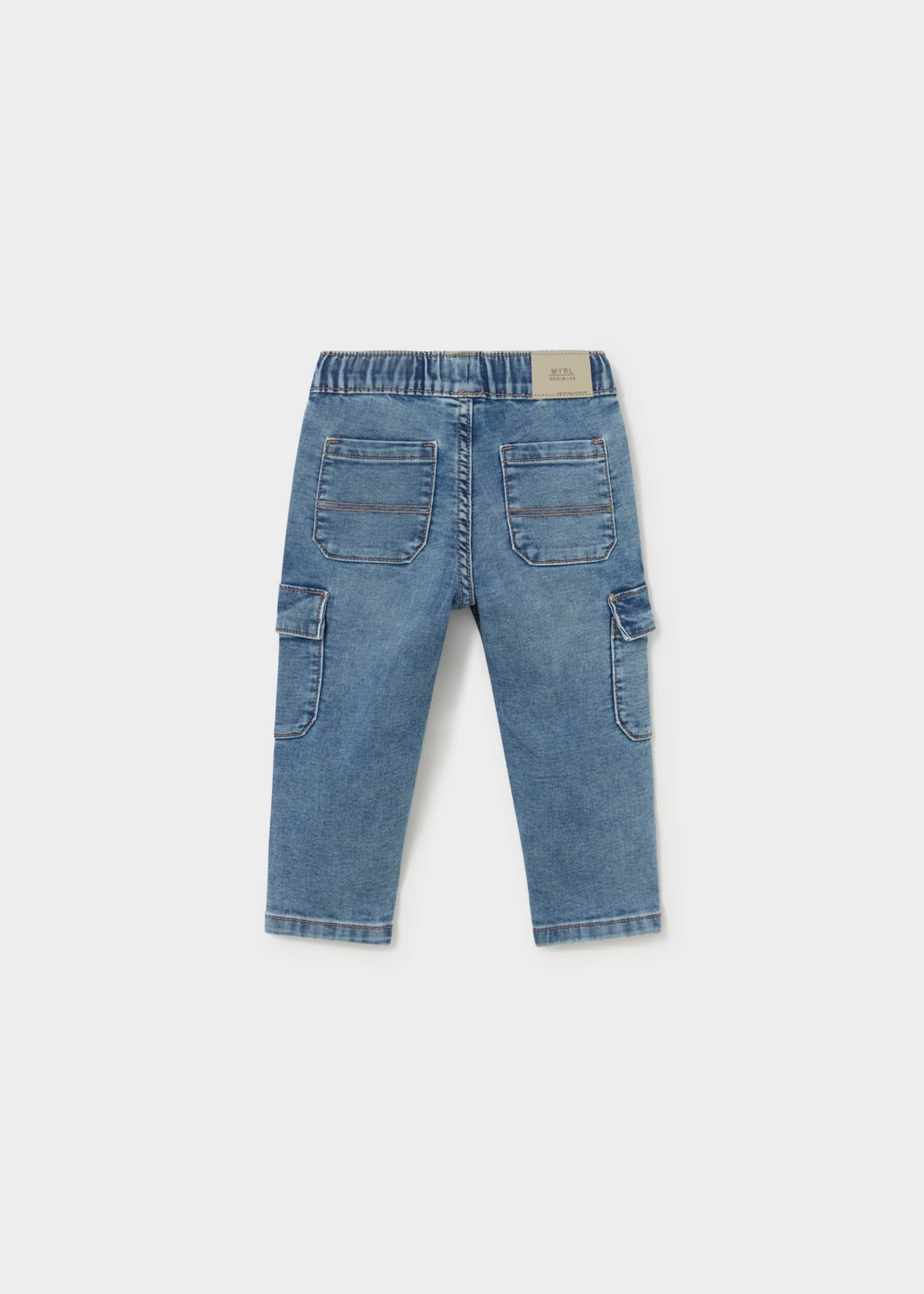 A pair of light blue denim cargo pants for kids, shown from the back against a light gray background.