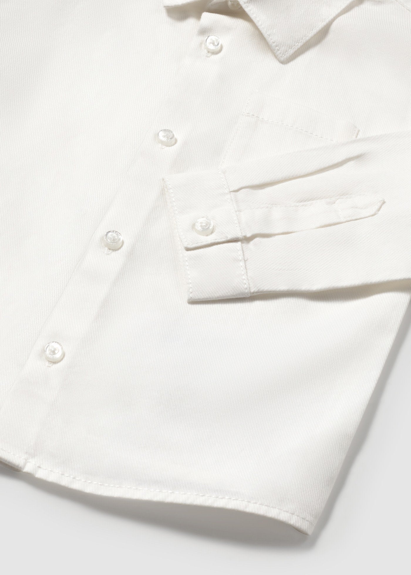 White shirt with buttons on a light gray background