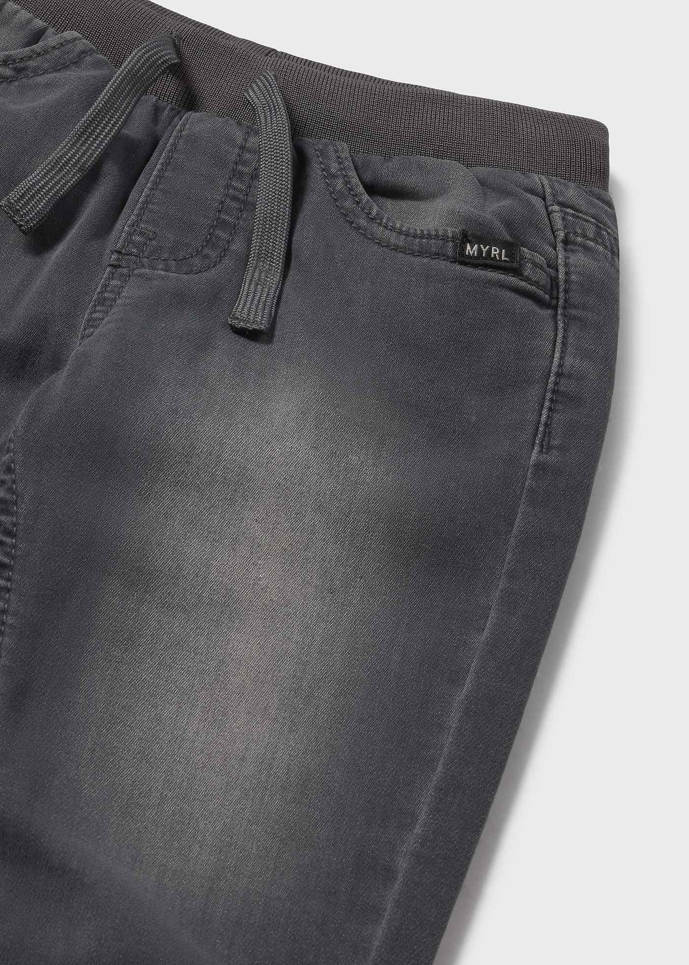 Dark gray pants with a brand label on a light gray background