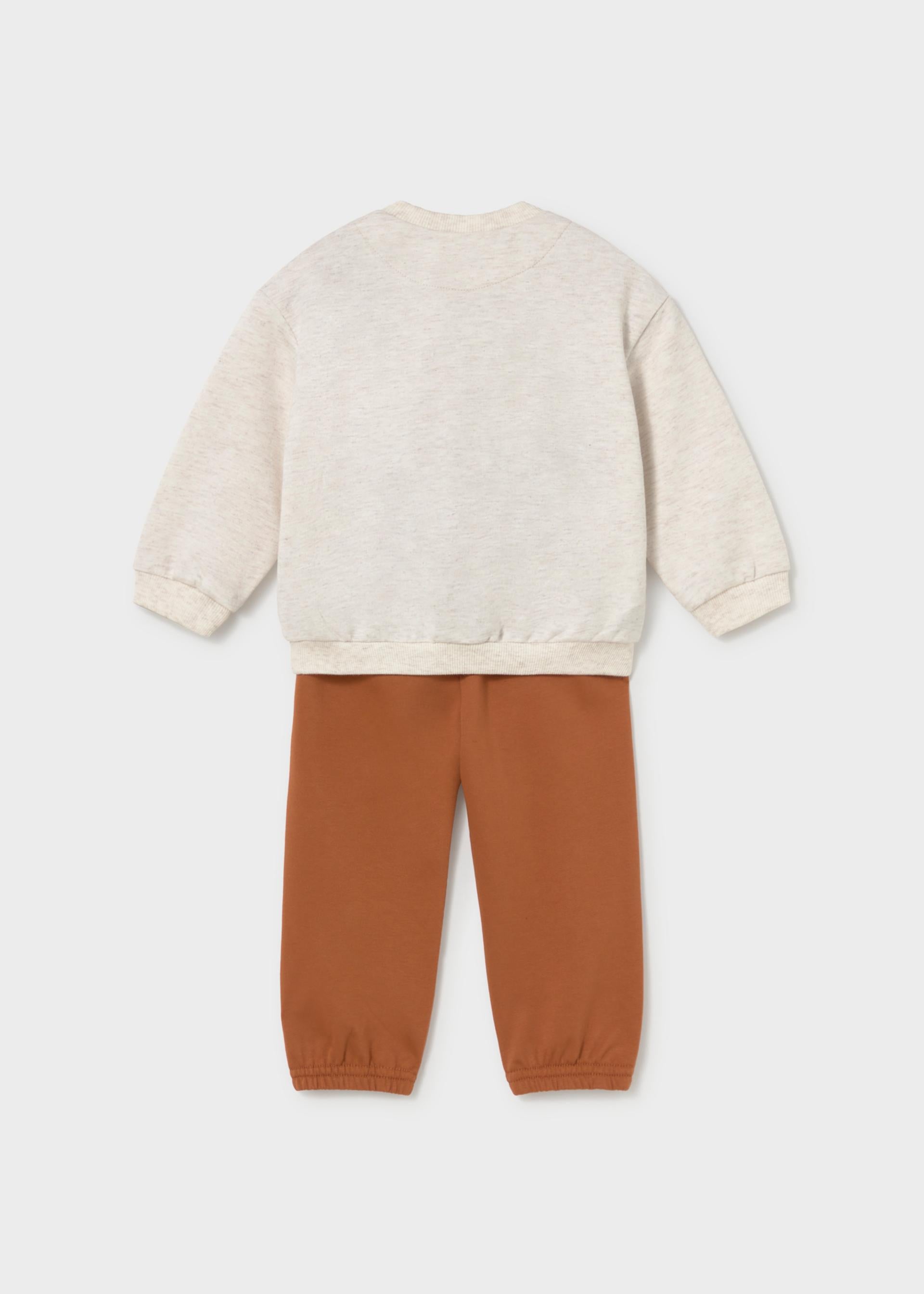 A two-piece children's outfit set featuring a long-sleeve crewneck sweatshirt in a light oatmeal cream color and matching jogger pants in a warm rust orange, shown from the back on a light gray background.