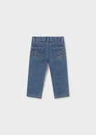 A pair of blue denim jeans shown from the back, featuring embroidered monogram details on the back pockets, displayed against a light gray background.