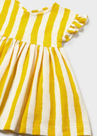 Yellow and white striped dress on a light gray background
