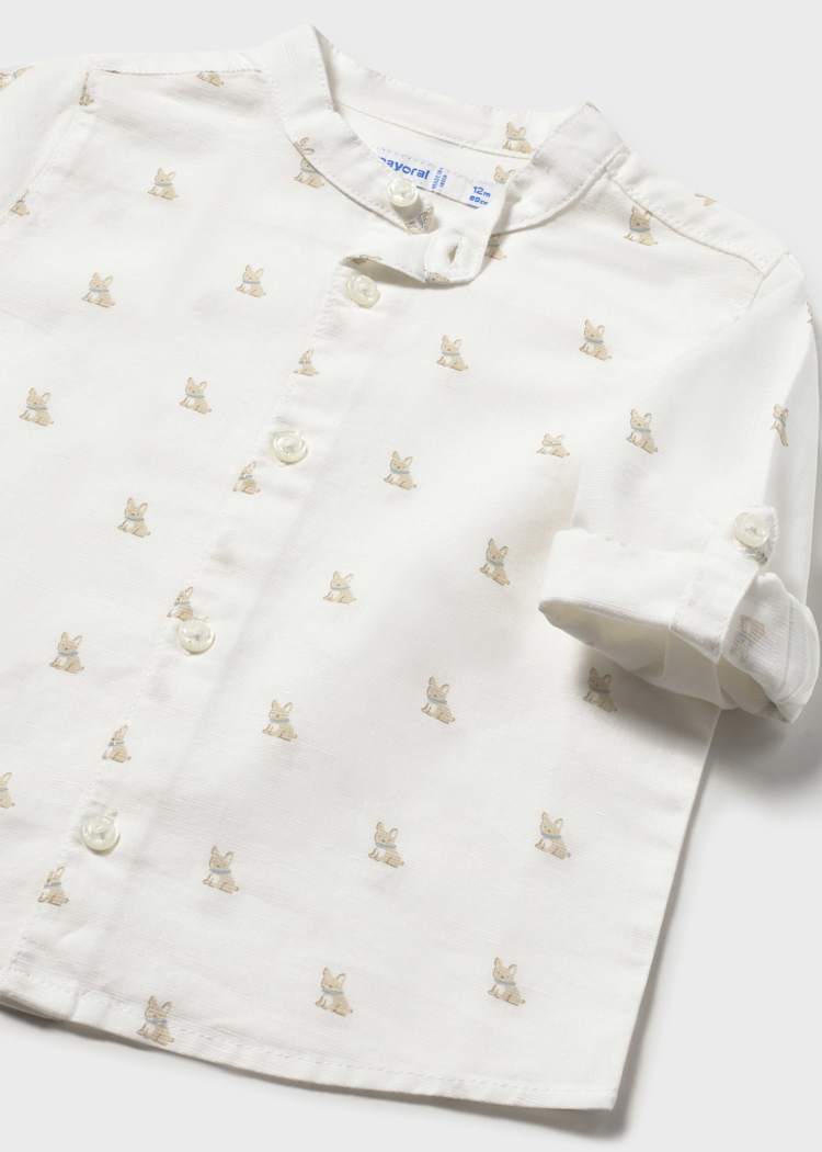 White shirt with small embroidered designs on a white background