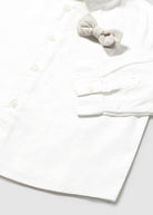 White baby outfit with a bow on a white background