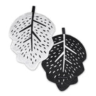 Two leaf-shaped coasters, one white and one black, with black text on a white background.