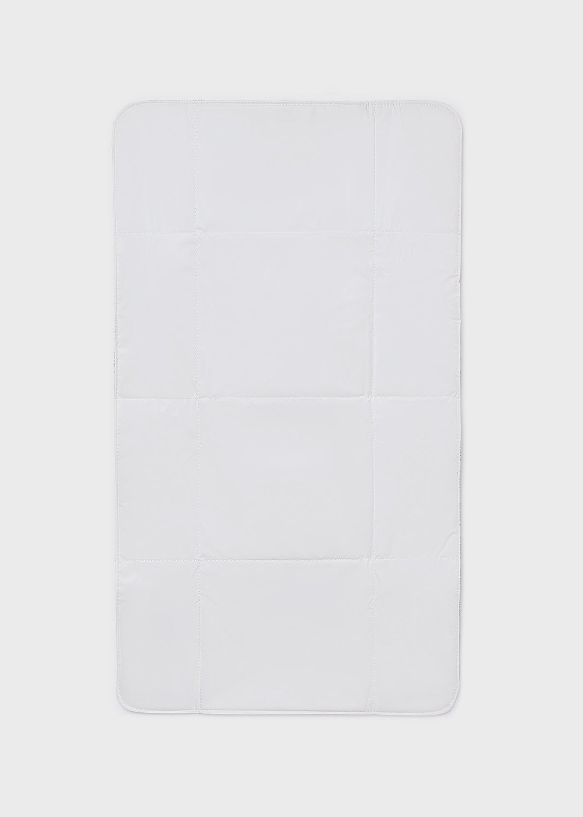 Rectangular white bath mat on a light gray background