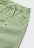 Close-up of green shorts on a white background