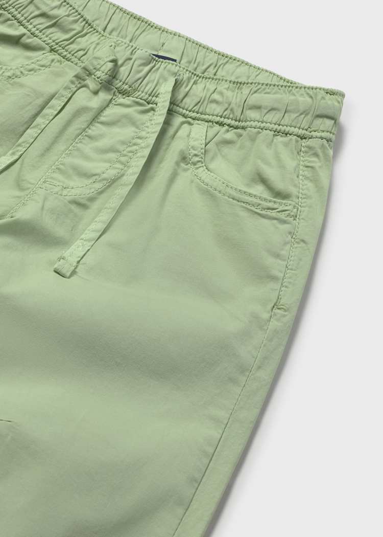 Close-up of green shorts on a white background