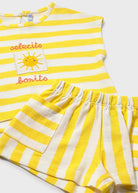 Yellow and white striped outfit with a sun design on a white background