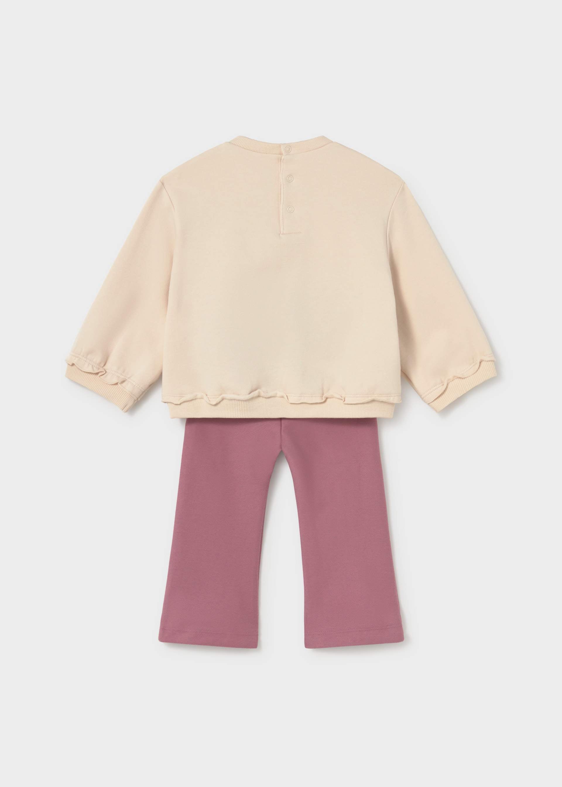 Beige top and pink pants on a white background