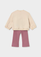 Beige top and pink pants on a white background