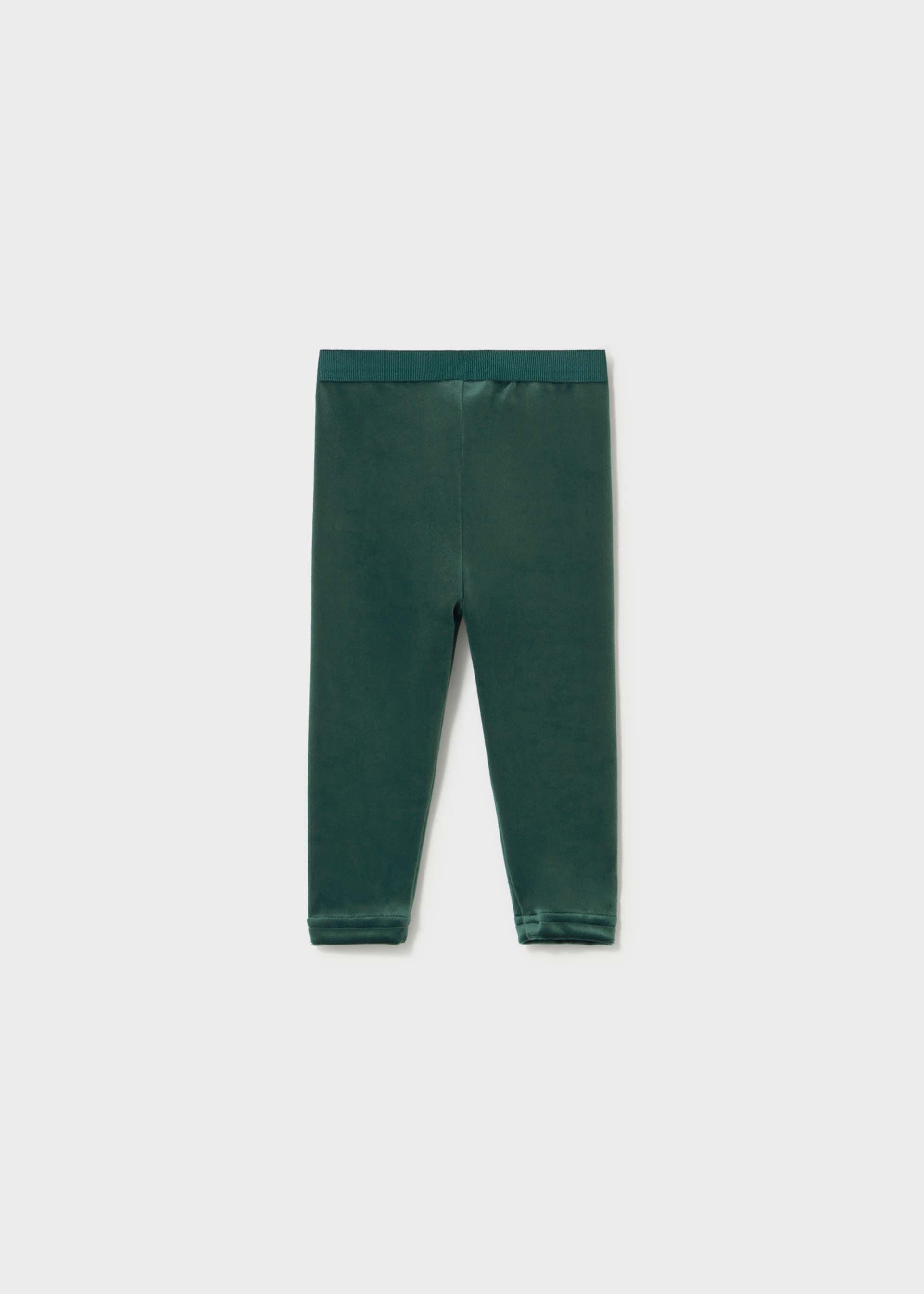 A pair of dark forest green leggings laid flat against a light gray background.