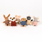Set of plush toy animals wearing colorful outfits on a white background
