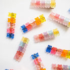 Colorful gummy bear-shaped hair clips on a white background