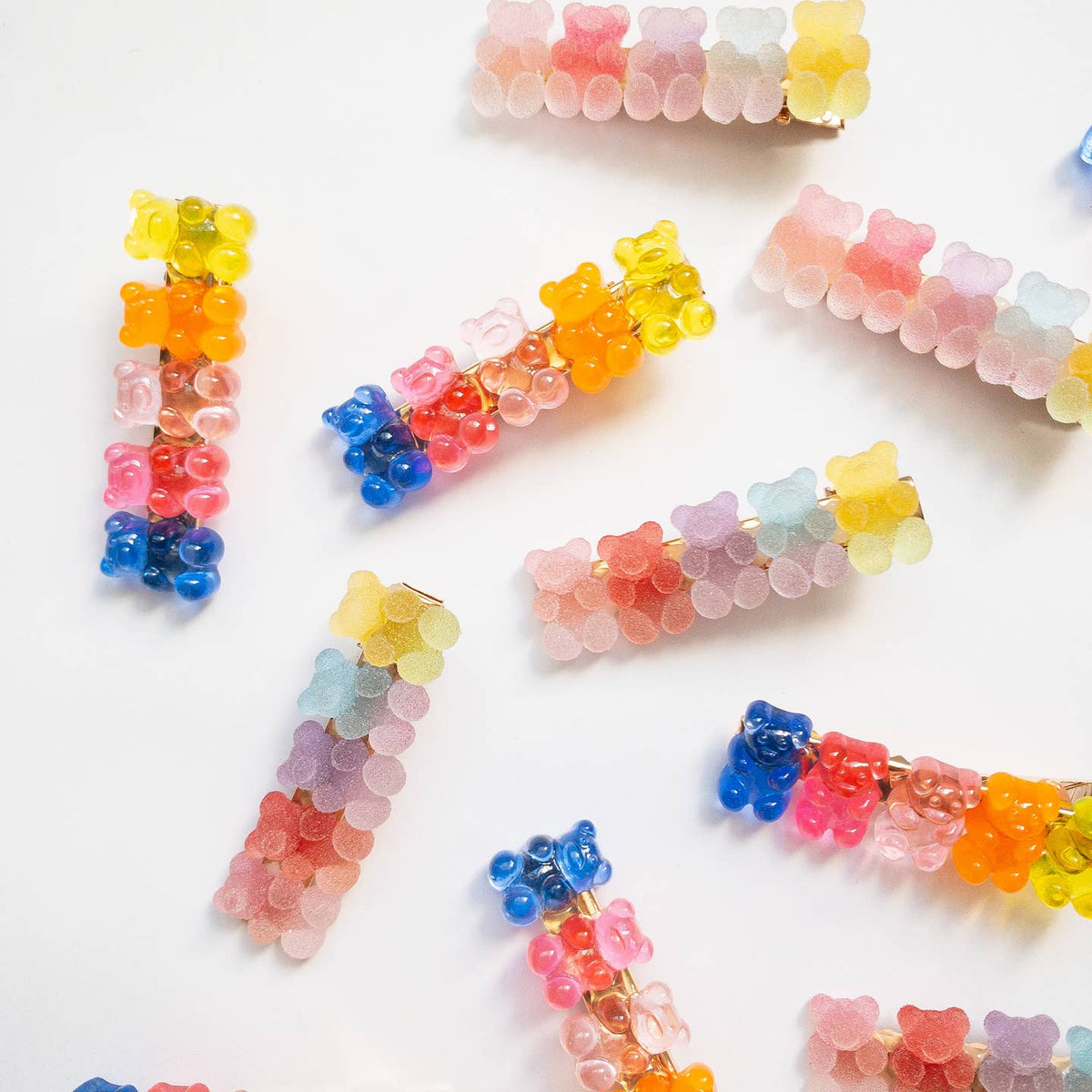 Colorful gummy bear-shaped hair clips on a white background