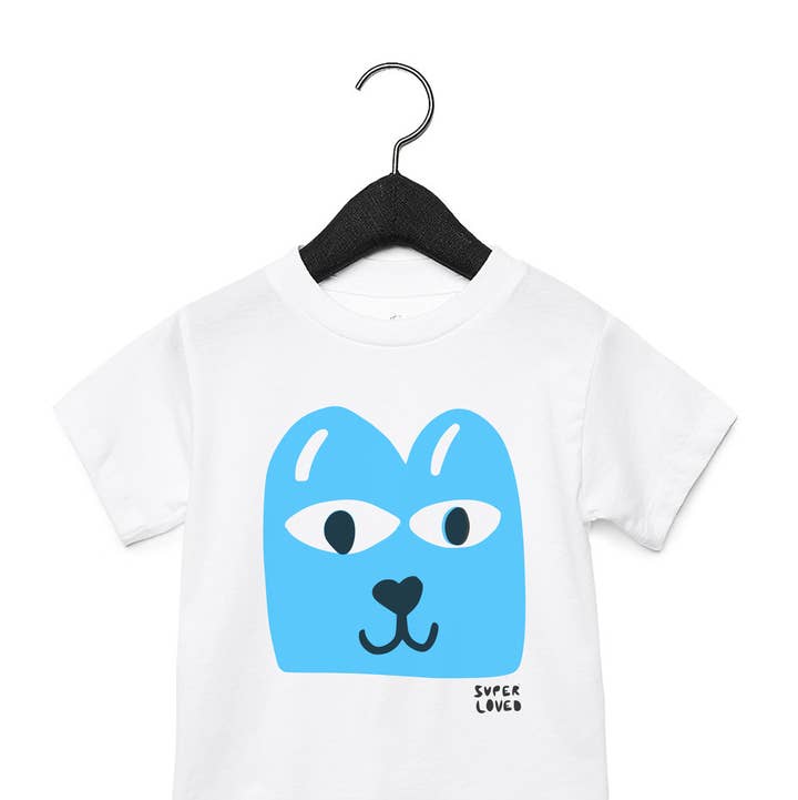 White t-shirt with blue graphic on a hanger against a white background